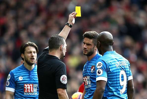 MANCHESTER, ENGLAND - MARCH 04: Andrew Surman of AFC Bournemouth (R) is shown his second yellow card of the game by referee Kevin Friend (L) during the Premier League match between Manchester United and AFC Bournemouth at Old Trafford on March 4, 2017 in Manchester, England. (Photo by Julian Finney/Getty Images)